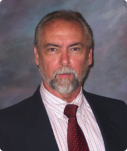 A man with a beard and suit jacket